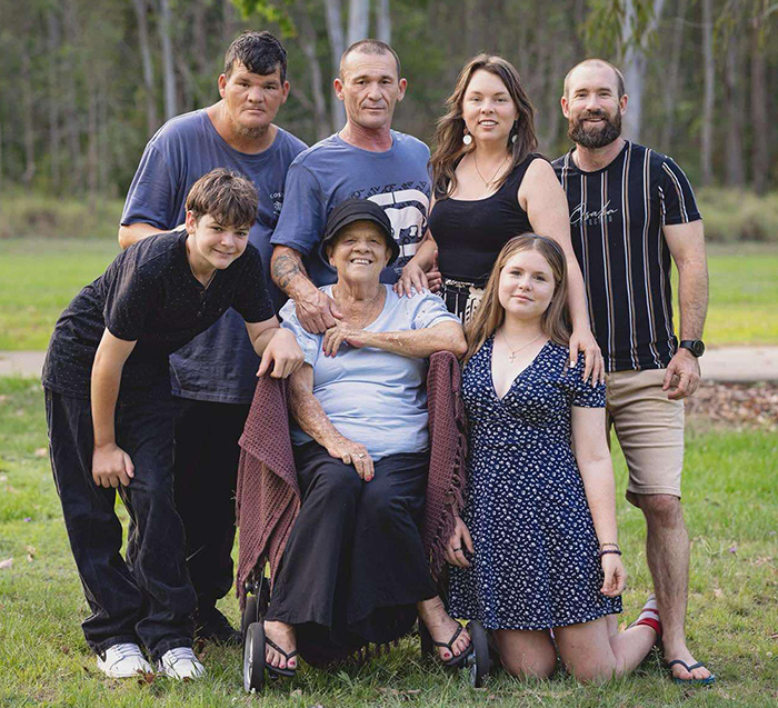 Lyn with her loving family, all smiles and united in strength, showcasing the warmth of togetherness during her cancer journey.